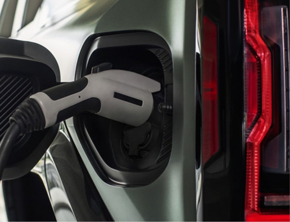 Close up of charging port with charger plugged in on a GMC Hummer EV SUV - Freedom Buick GMC Greenville by Ed Morse in GREENVILLE TX